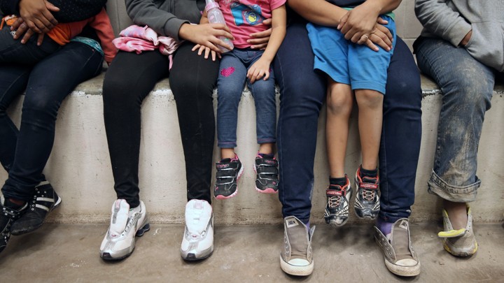 Women and children sit in a holding cell at a U.S. Border Patrol center