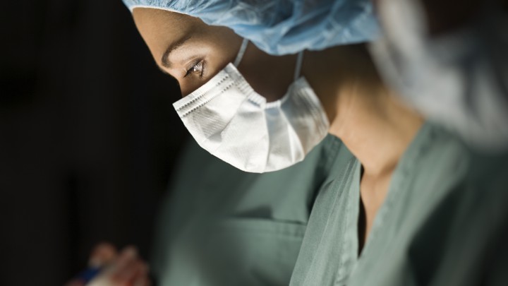 A female surgeon operating