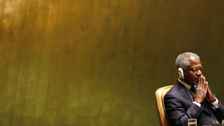 Annan sits with headphones as he listens to George W. Bush at the UN General Assembly in 2006.