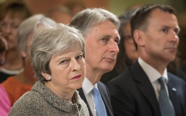 British Prime Minister Theresa May sits next to Chancellor of the Exchequer Philip Hammond and Foreign Secretary Jeremy Hunt during an event in London on June 18, 2018.