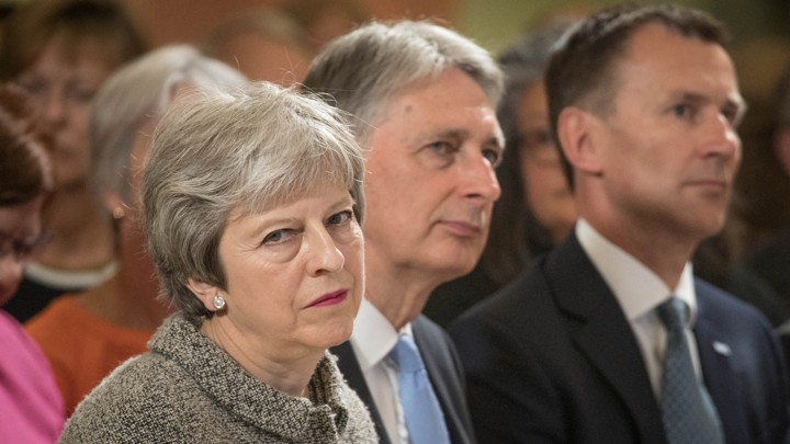 British Prime Minister Theresa May sits next to Chancellor of the Exchequer Philip Hammond and Foreign Secretary Jeremy Hunt during an event in London on June 18, 2018.