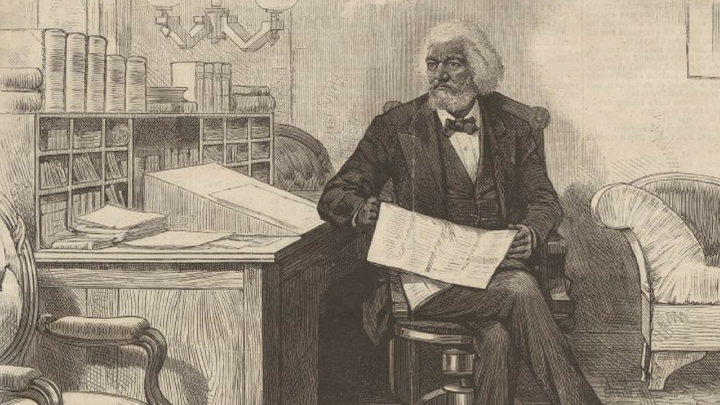 An illustration of Frederick Douglass sitting with a writing box atop his desk