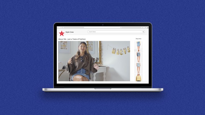 A laptop shows a video a girl sitting and gesturing in a decorated room