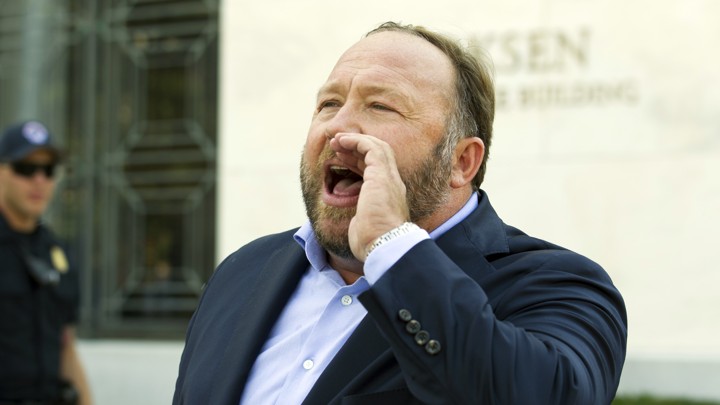 A man yelling with his hand cupped to his face