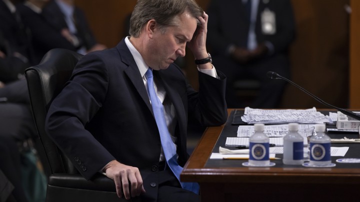 Brett Kavanaugh sits at a desk during his Senate hearing.