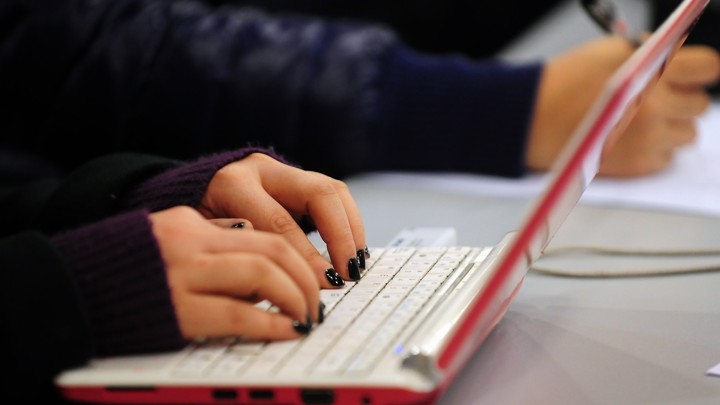 A person types on a laptop's keyboard.