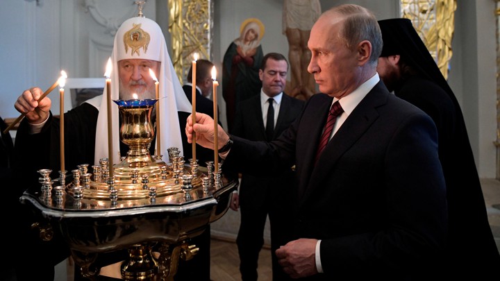 Vladimir Putin and Kirill, the patriarch of the Russian Orthodox Church, light candles at a ceremony at a monastery near Moscow in 2017.