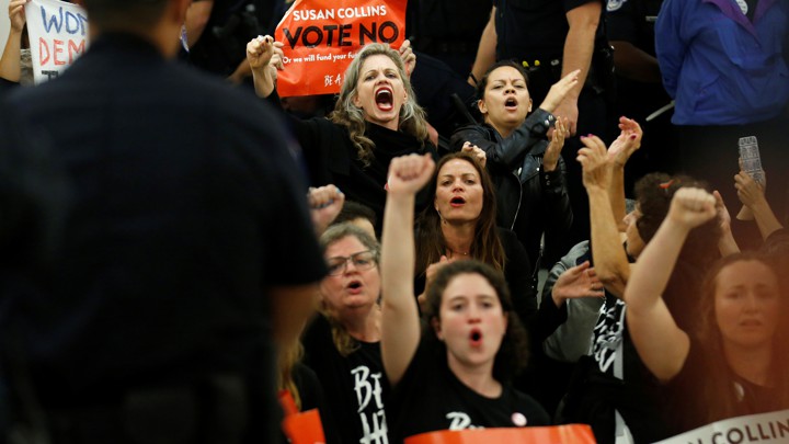 Protesters against Brett Kavanaugh chant in front of the office of Senator Susan Collins on September 24, 2018.