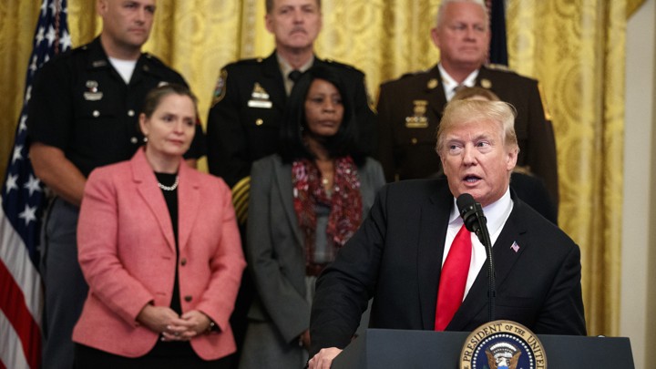 Trump addresses a crowd from a podium