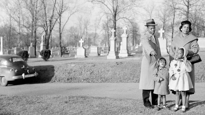 John A. Madison, great-grandson of Dred Scott, points to his ancestor's unmarked grave.