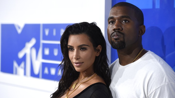 Kim Kardashian and Kanye West pose for a photo