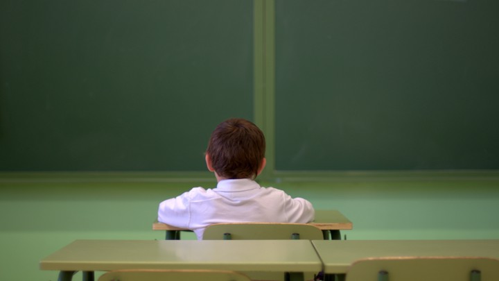 A young boy sitting at his desk