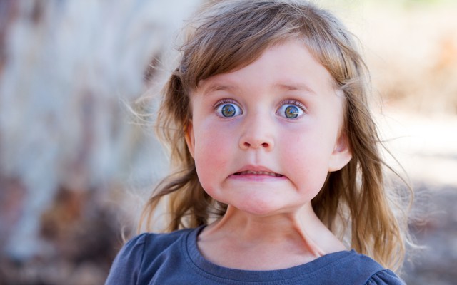 A young girl with a "yikes!" expression