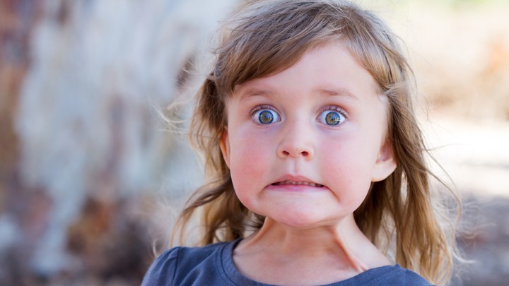 A young girl with a "yikes!" expression