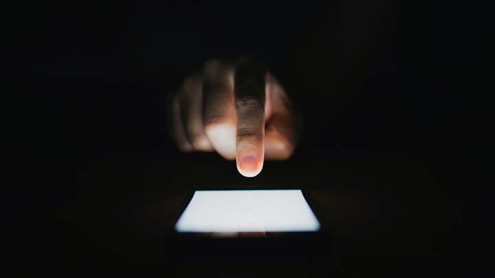 A person types on a smartphone.