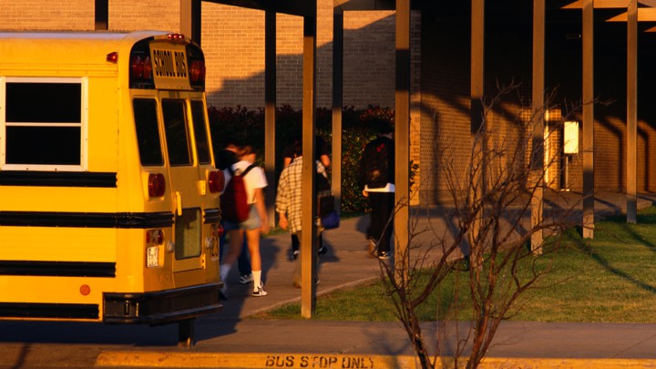 Students get off a school bus.
