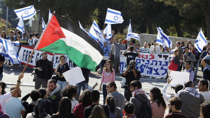 Protesters hold pro-Israel and pro-Palestine posters during a demonstration in Jerusalem.