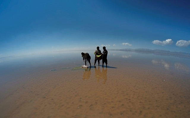 Men perform a ceremony on the drought-stricken bed of Poopo, a lake in Bolivia