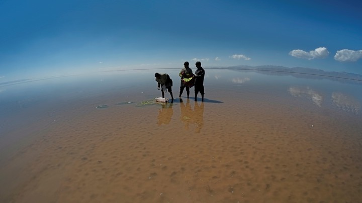 Men perform a ceremony on the drought-stricken bed of Poopó, a lake in Bolivia.