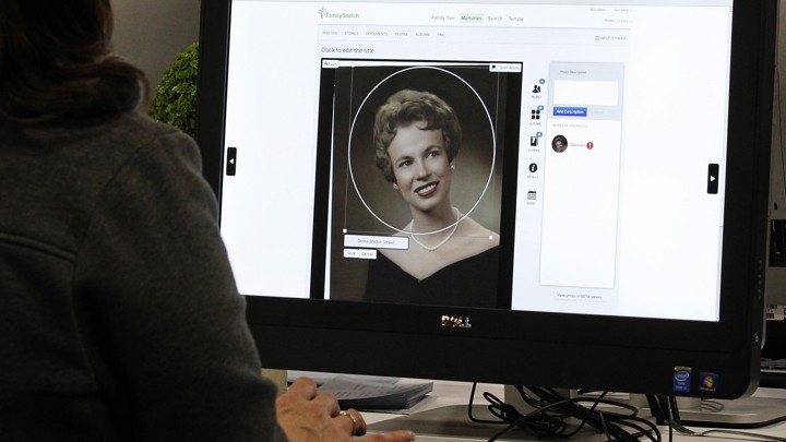 A person uses a computer to look at family history on a genealogy website.