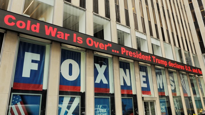 A Fox News ticker shows headlines from the Trump-Putin meeting in Helsinki