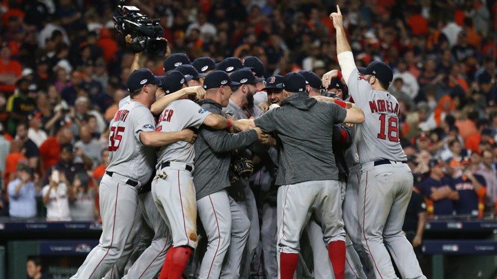 Boston Red Sox players celebrate on the field after defeating the Houston Astros on October 19.
