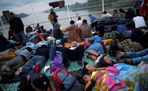 Honduran migrants, part of the caravan trying to reach the U.S., wait to open the gate on the bridge that connects Mexico and Guatemala on October 20, 2018