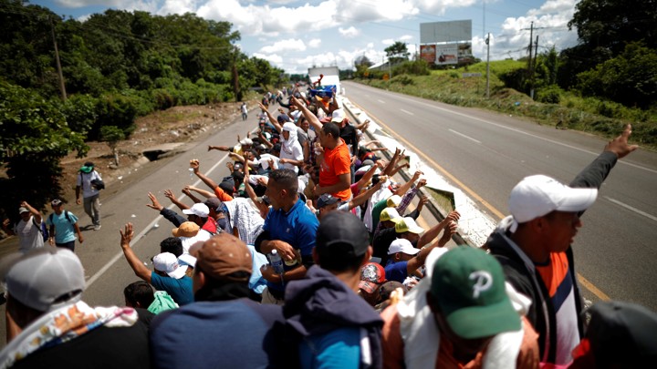 Central American migrants hitchhike on a truck along the highway as they continue their journey in Tapachula, Mexico, on October 22, 2018.