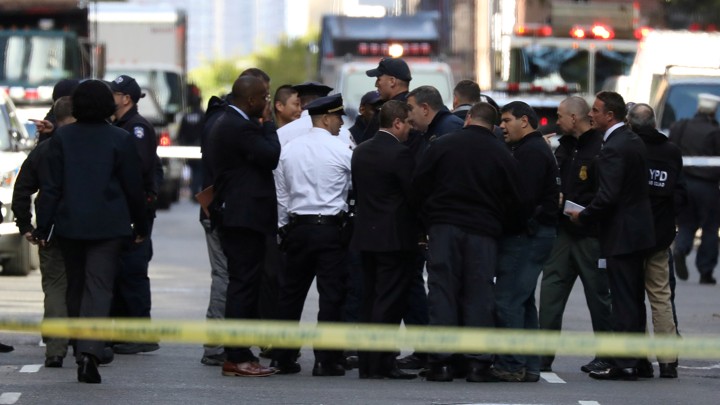 Police stand outside of the Time Warner building after a suspicious package was found inside CNN Headquarters