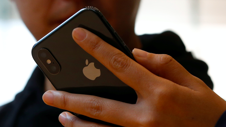 A man unlocks his phone with facial recognition.