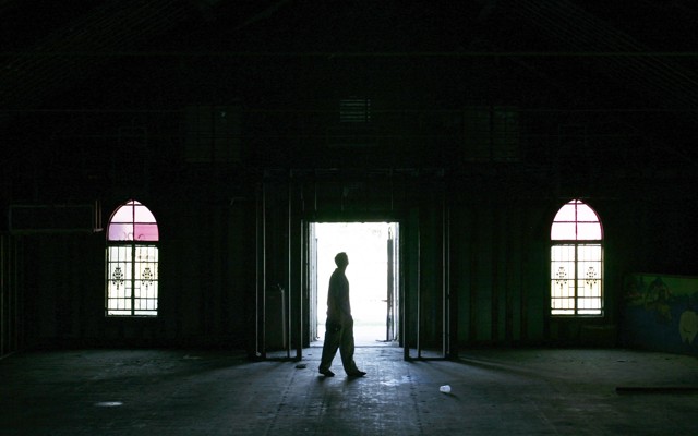A man walks inside an empty church in the Ninth Ward area in New Orleans