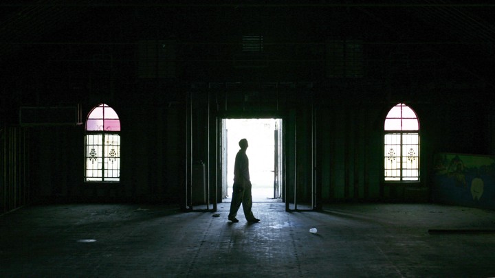 A man walks inside an empty church in the Ninth Ward area in New Orleans