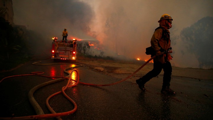 Firefighters battle the Woolsey Fire in Malibu, which closed down a major freeway.