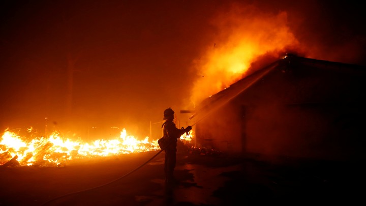 A firefighter battles the Woolsey Fire in Malibu