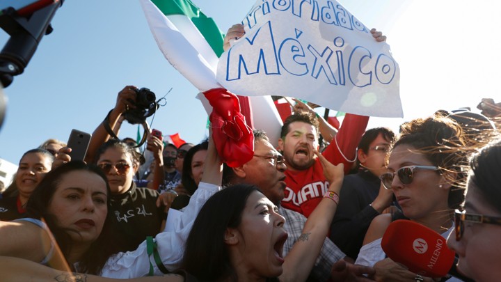 A pro-migration activist argues with demonstrators during a protest against migrants who are part of a caravan traveling en route to the United States, in Tijuana, Mexico November 18, 2018.