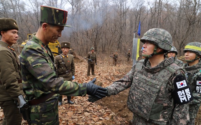 A South Korean military officer and a North Korean military officer shake hands near the demilitarized zone separating the two Koreas on November 22.