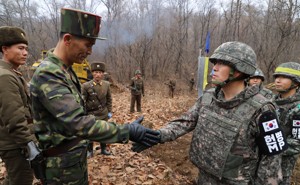 A South Korean military officer and a North Korean military officer shake hands near the demilitarized zone separating the two Koreas on November 22.