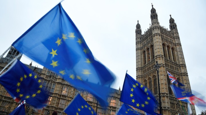 Anti-Brexit protesters wave EU flags outside Britain's parliament.