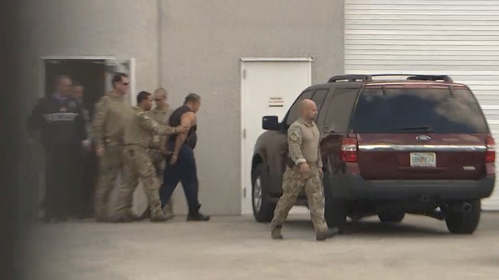 FBI officers escort Cesar Sayoc to a waiting SUV after his arrest in Miramar, Florida, on October 26.