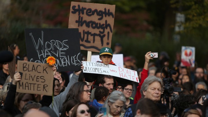 People march in memory of the victims of the Tree of Life synagogue shooting.