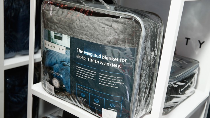 A gray blanket in plastic packaging