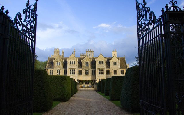 A picture of a large estate behind a set of gates