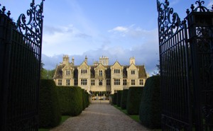 A picture of a large estate behind a set of gates
