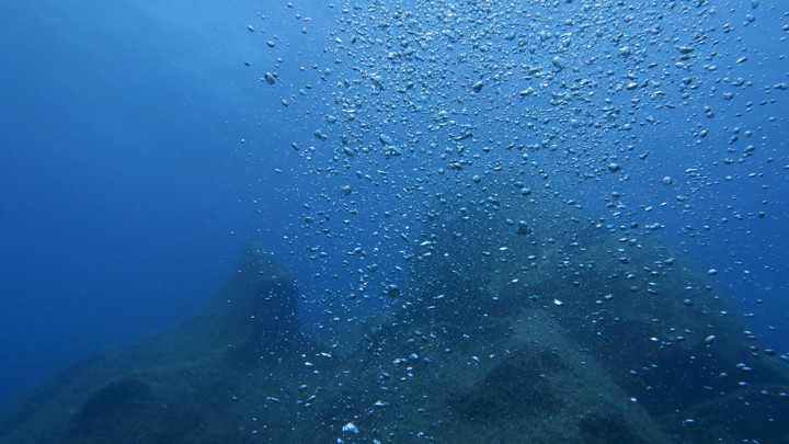 Bubbles in the ocean rise to the surface.