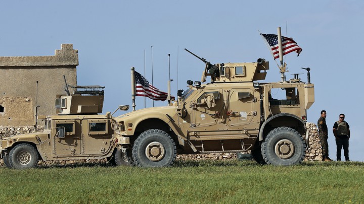 Syrian soldiers stand at a U.S. outpost near Manbij, Syria, in March 2018.