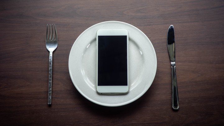 An empty plate with an iPhone on it