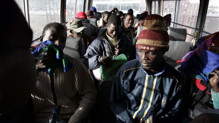 Would-be immigrants sit in a police bus in Nouadhibou, Mauritania, after being detained while trying to leave for Europe.