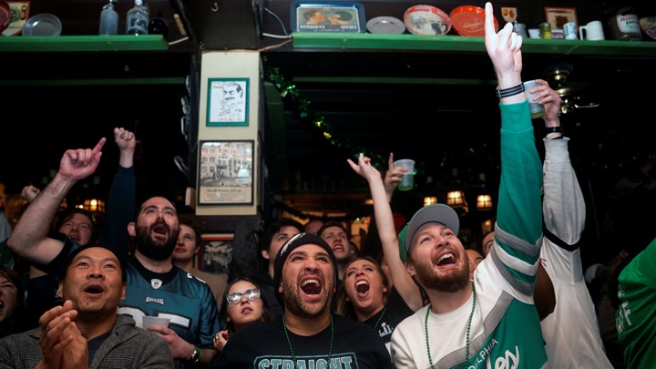 Football fans watch the Super Bowl.