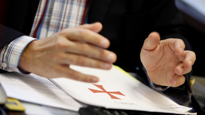 The Flemish right-wing party member Tanguy Veys holds his hands over a copy of Anders Behring Breivik's manifesto.