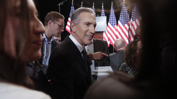 Former Starbucks CEO Howard Schultz mingles in a crowd.